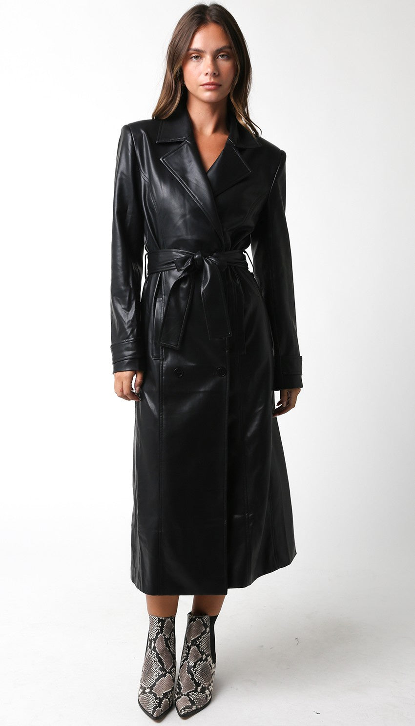 Featuring a faux leather long sleeve trench coat with a tie front