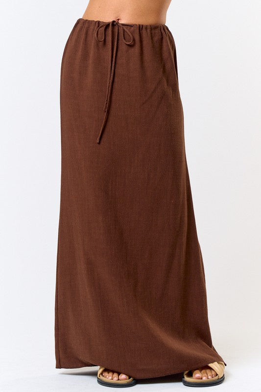 Featuring a full length linen maxi skirt with a front tie in the color brown 