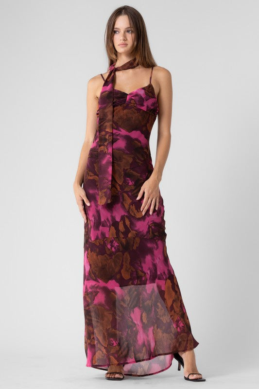 Featuring a woven floral print maxi dress with a mini scarf in the color plum and brown 