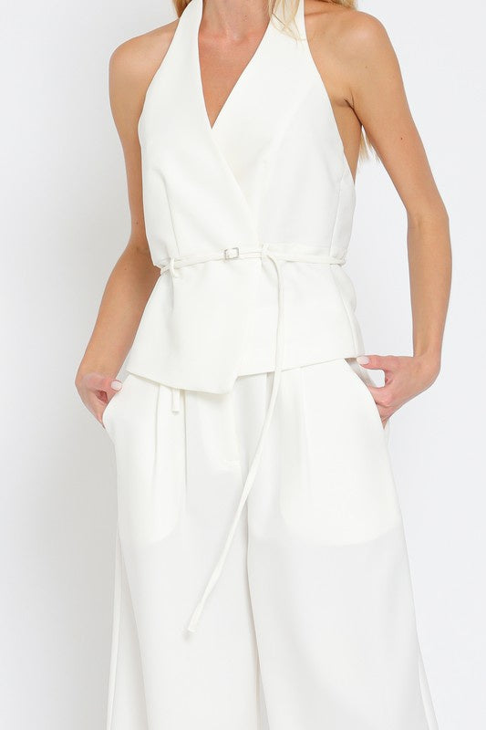 Featuring a halter backless top with a belt in the color white