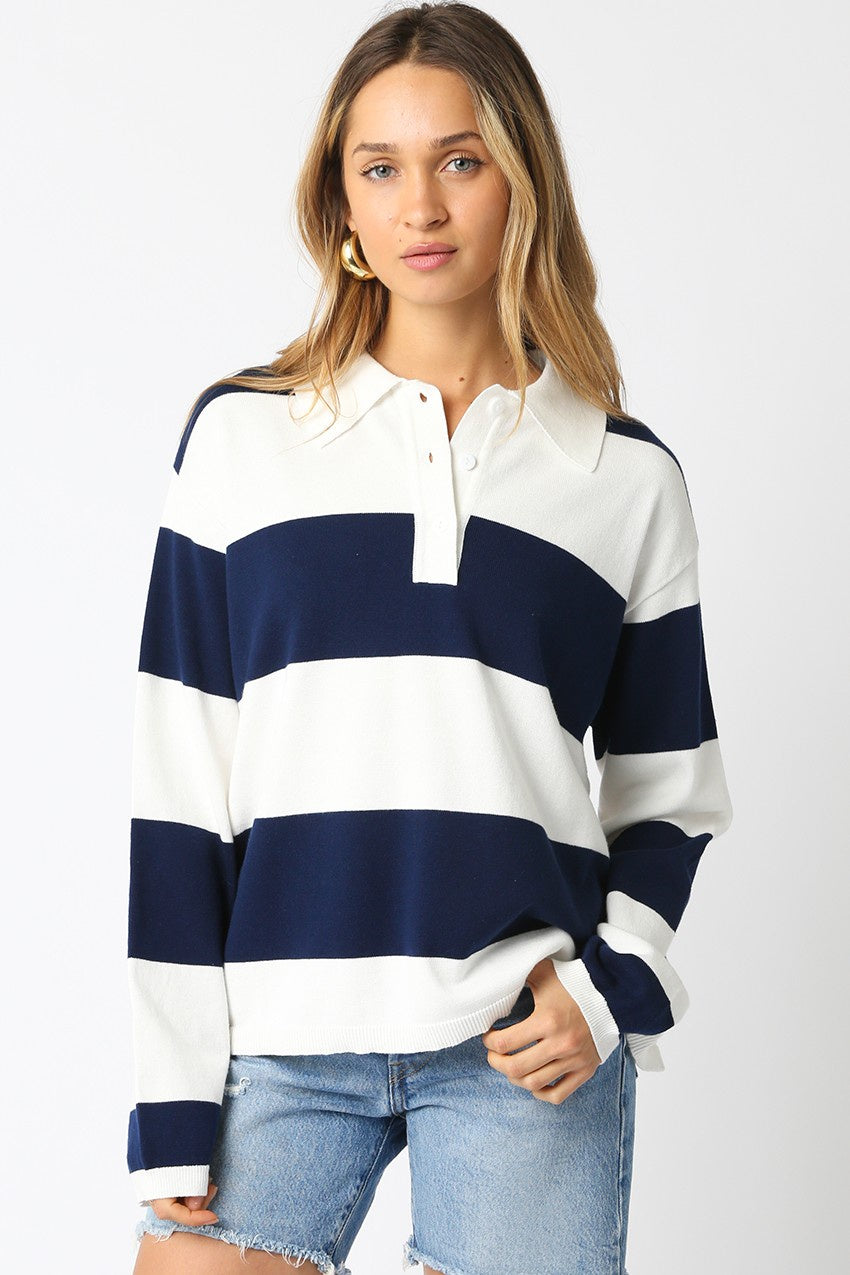 Featuring an over sized collard striped sweater top in the colors navy and white stripe