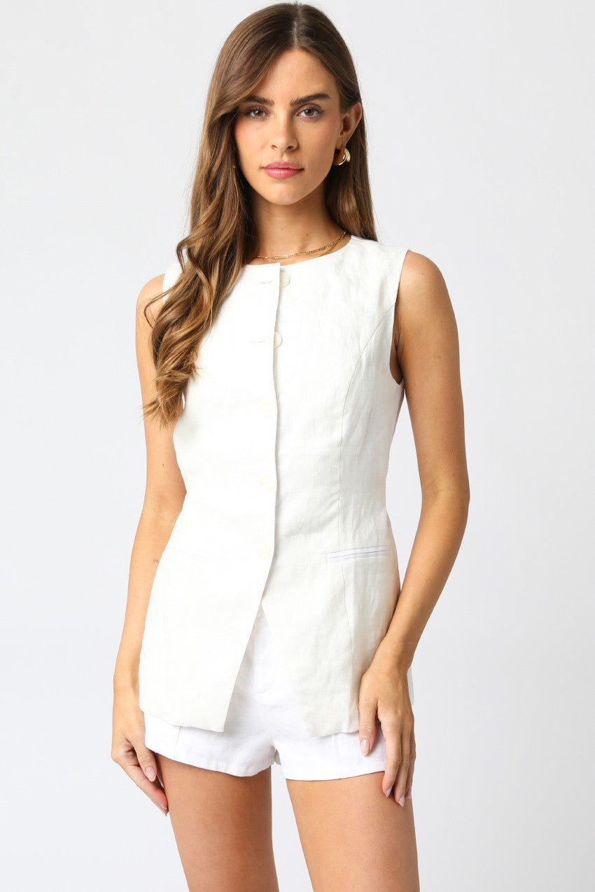 Featuring a white button down high neck vest with adjustable strap