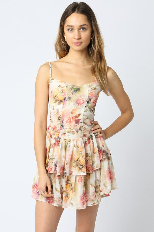 Featuring a multi color, floral printed mini dress with a ruffled hem 