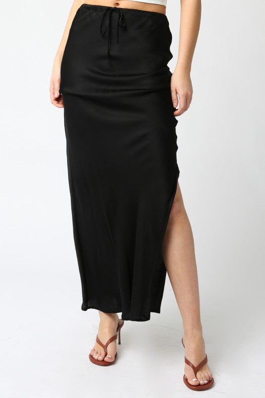 Featuring a black satin midi skirt with front waist tie and side slit