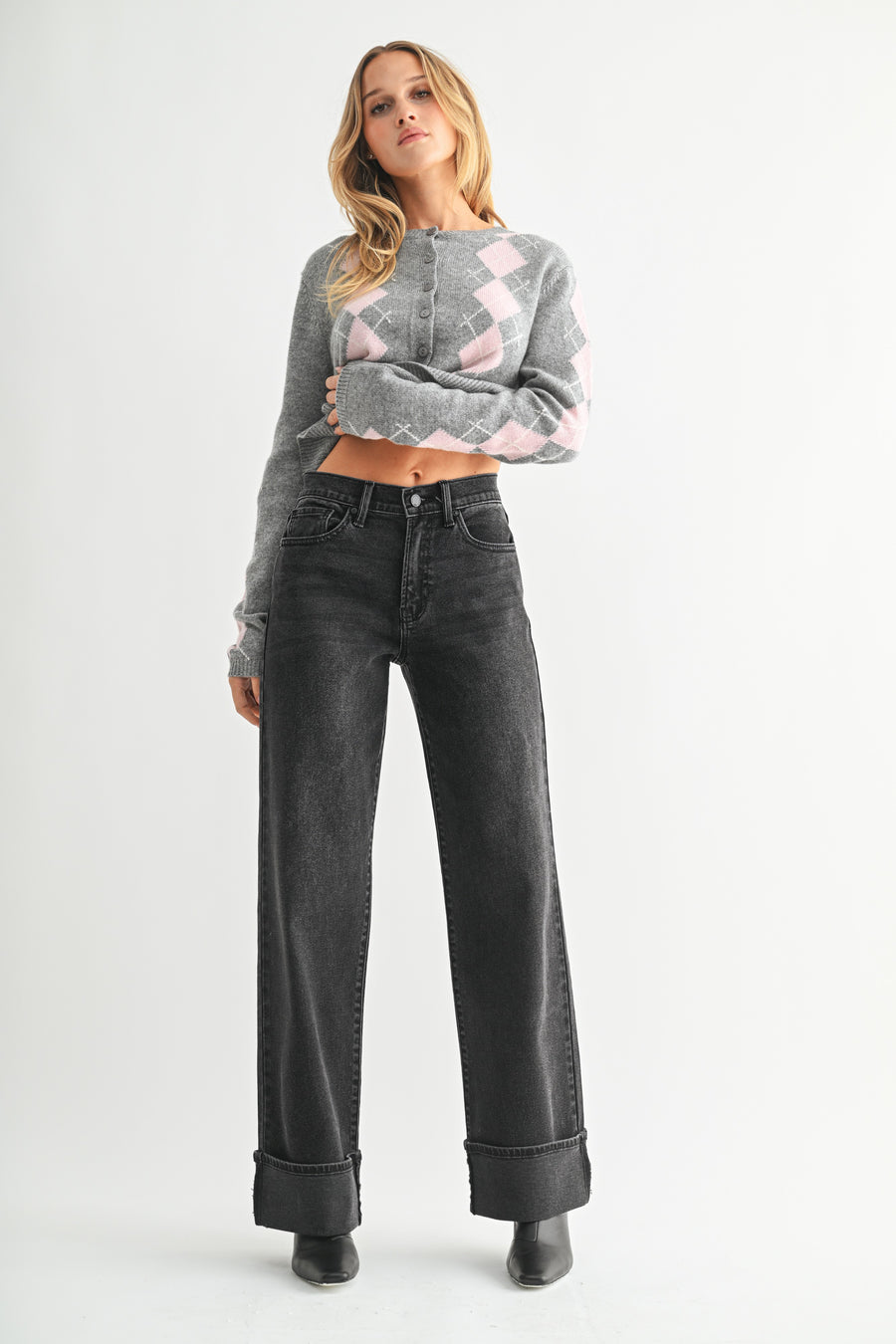 Featuring a high rise, wid leg, washed black denim jean with a wide cuff