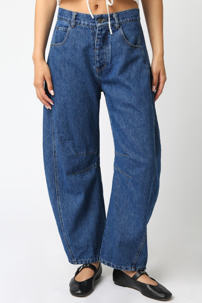 Featuring a baggy barrel style Jean in a medium dark wash
