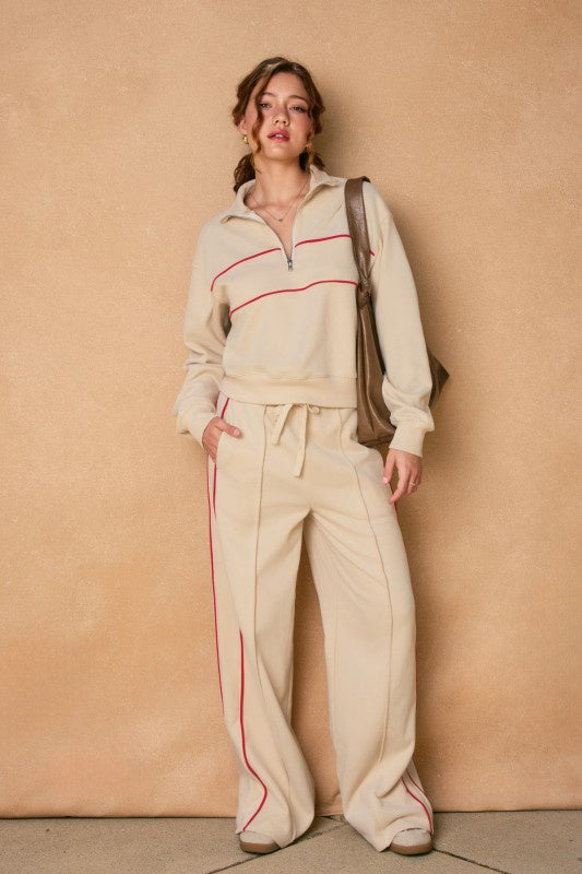 Featuring a high waisted lounge pant with drawstring fastening and side pockets
