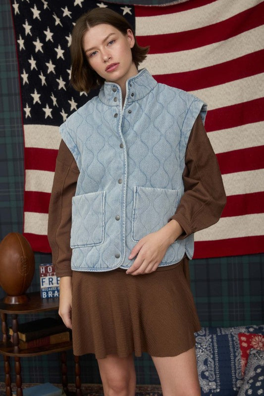 Featuring a washed denm quilted button down vest