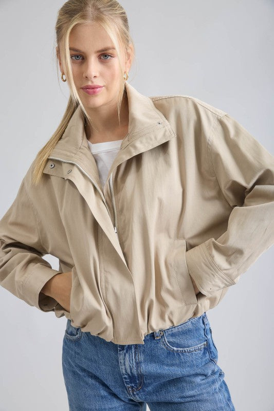 Featuring a mock neck zip up jacket with elastic hem and cuffs