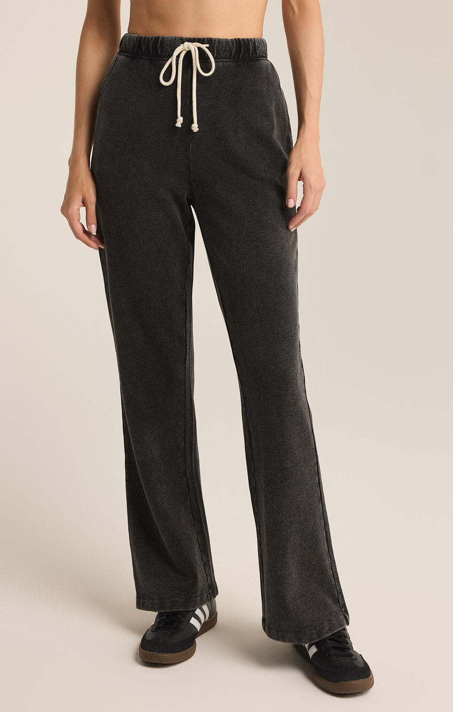 Featuring a denim wash knit sweat pant with draw strings in the color vintage black 