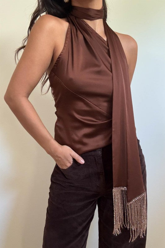 Featuring a silk one shoulder top with a scarf detail