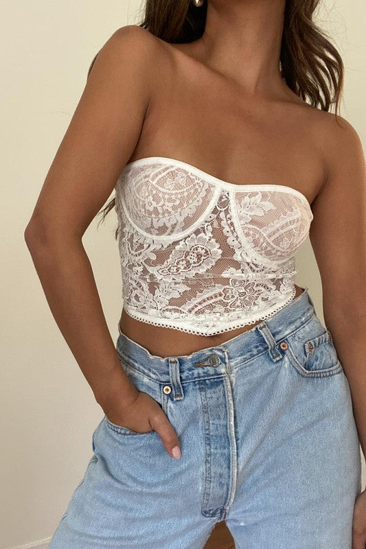 Featuring a bandana style lace tube top in the color white 