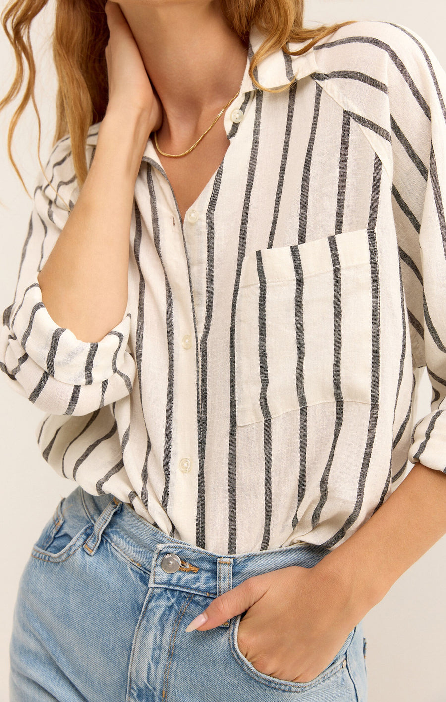 Featuring a striped long sleeve light weight button up with chest pocket detail in black and white stripe