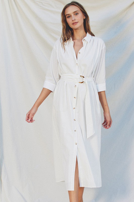 Featuring a button up midi dress with a three quarter sleeve and a belt detail in the color off white 