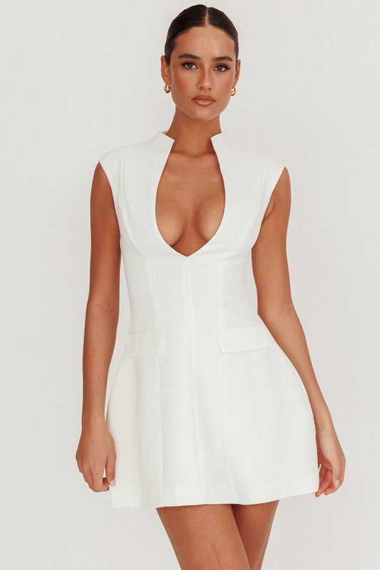 Featurng a low cut slevless mini dress with flap pickets and a zipper back in the color white 