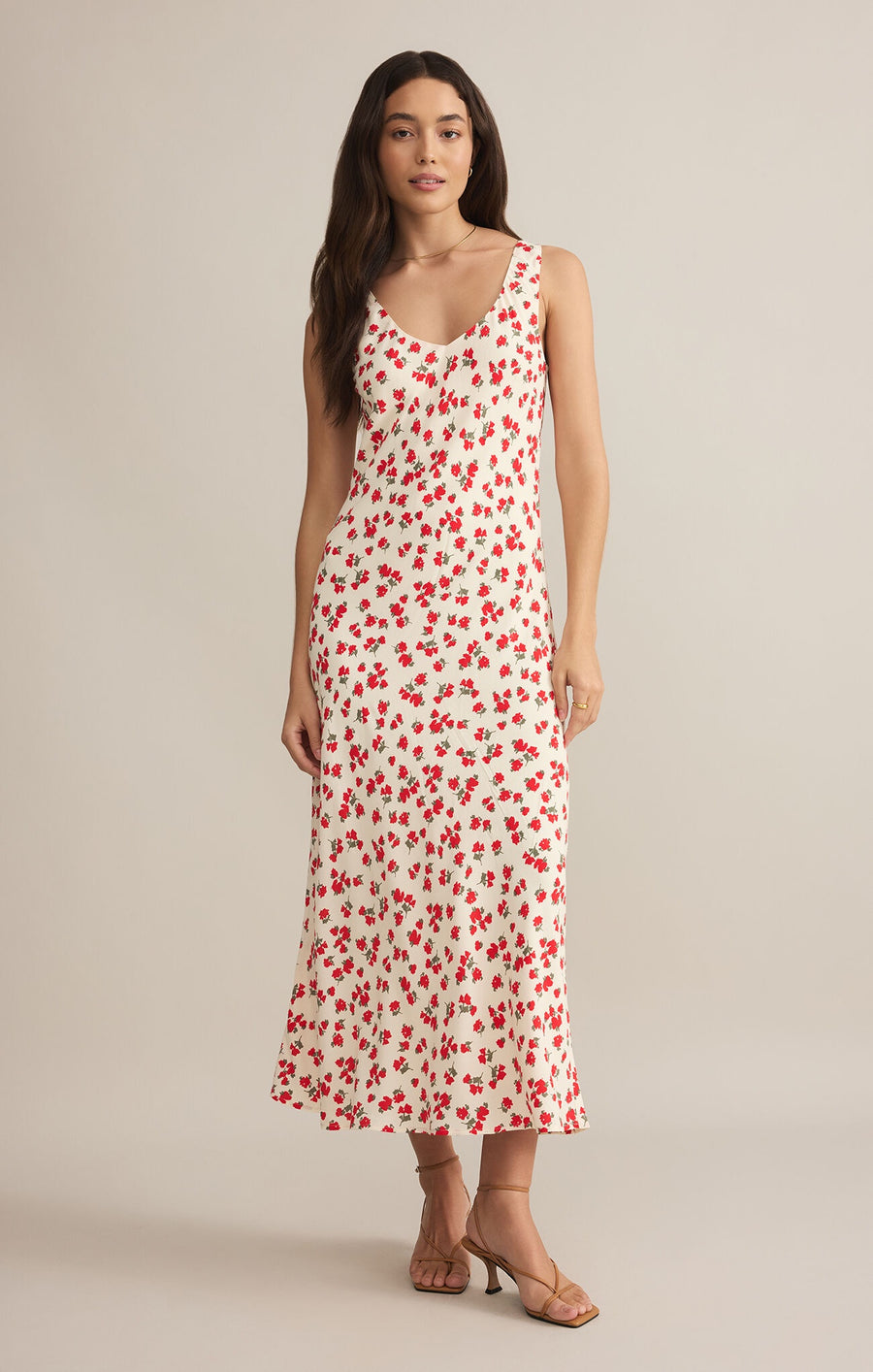 Featuring a v-neck sleeveless maxi dress with a floral print in the color sea salt with roses 