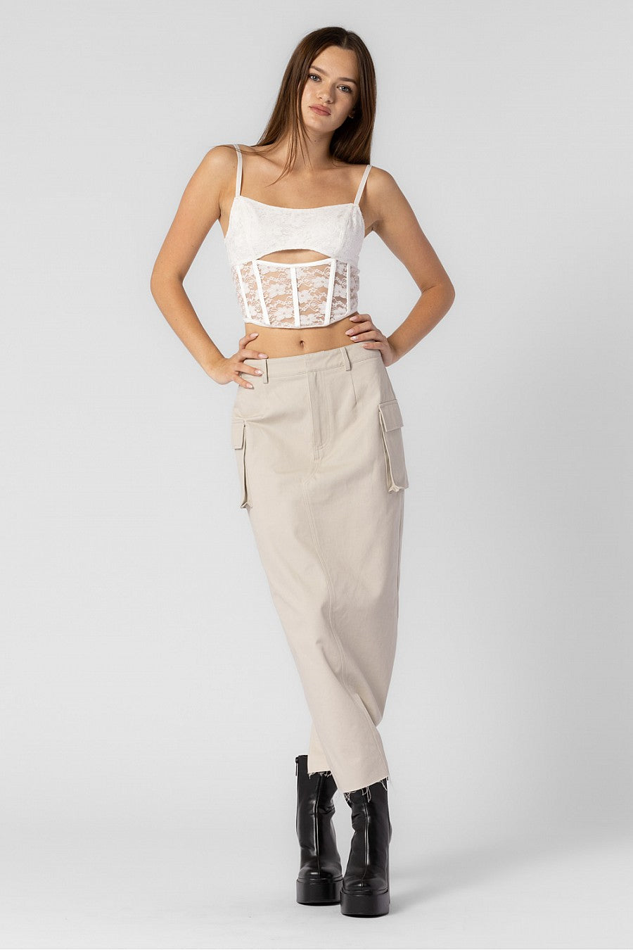 Model is wearing a maxi cargo skirt with side pockets.