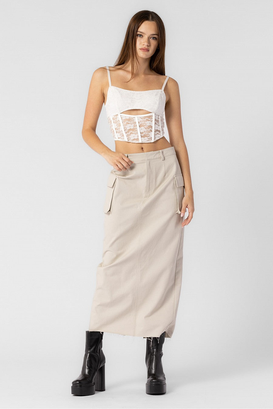 Model is wearing a maxi cargo skirt with side pockets.