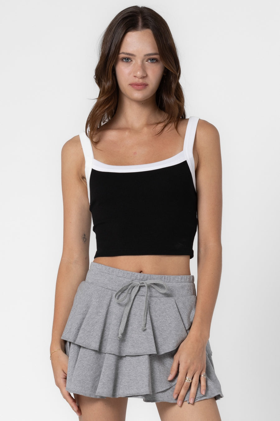 Featuring a cropped ribbed tank in the color black and off white 