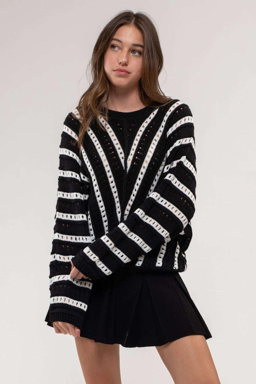 Black knitted sweater with ivory stripes. 
