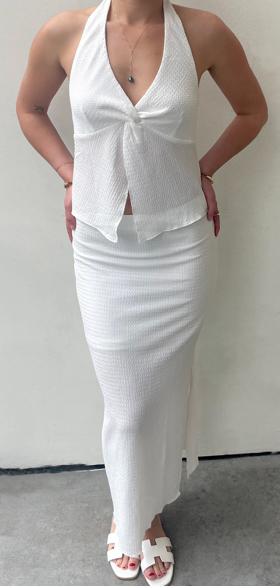 Featuring a Midi skirt with a built in slip and side slit detail in the color white 