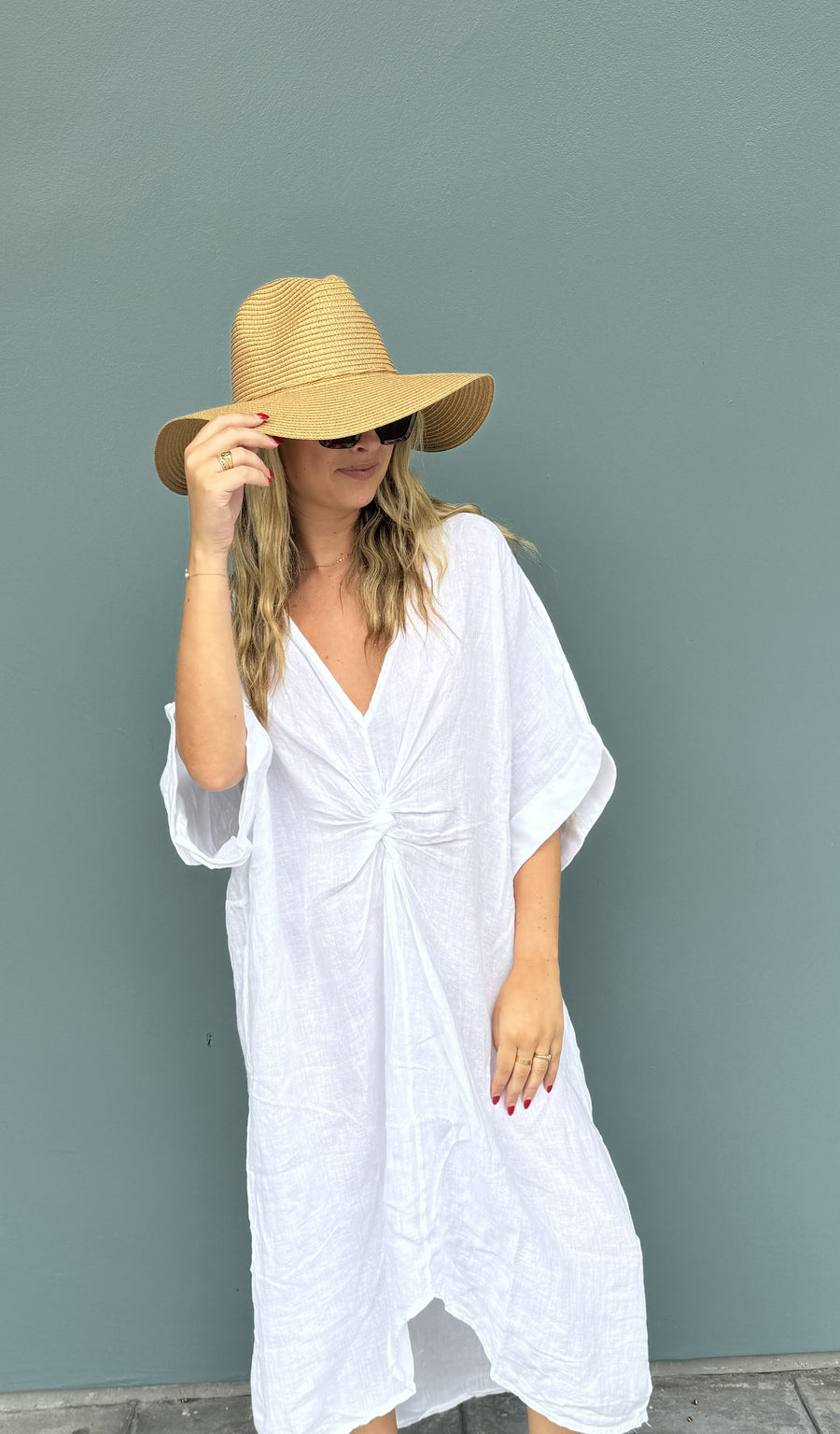 Featuring a linen twist front beach cover up in the color white