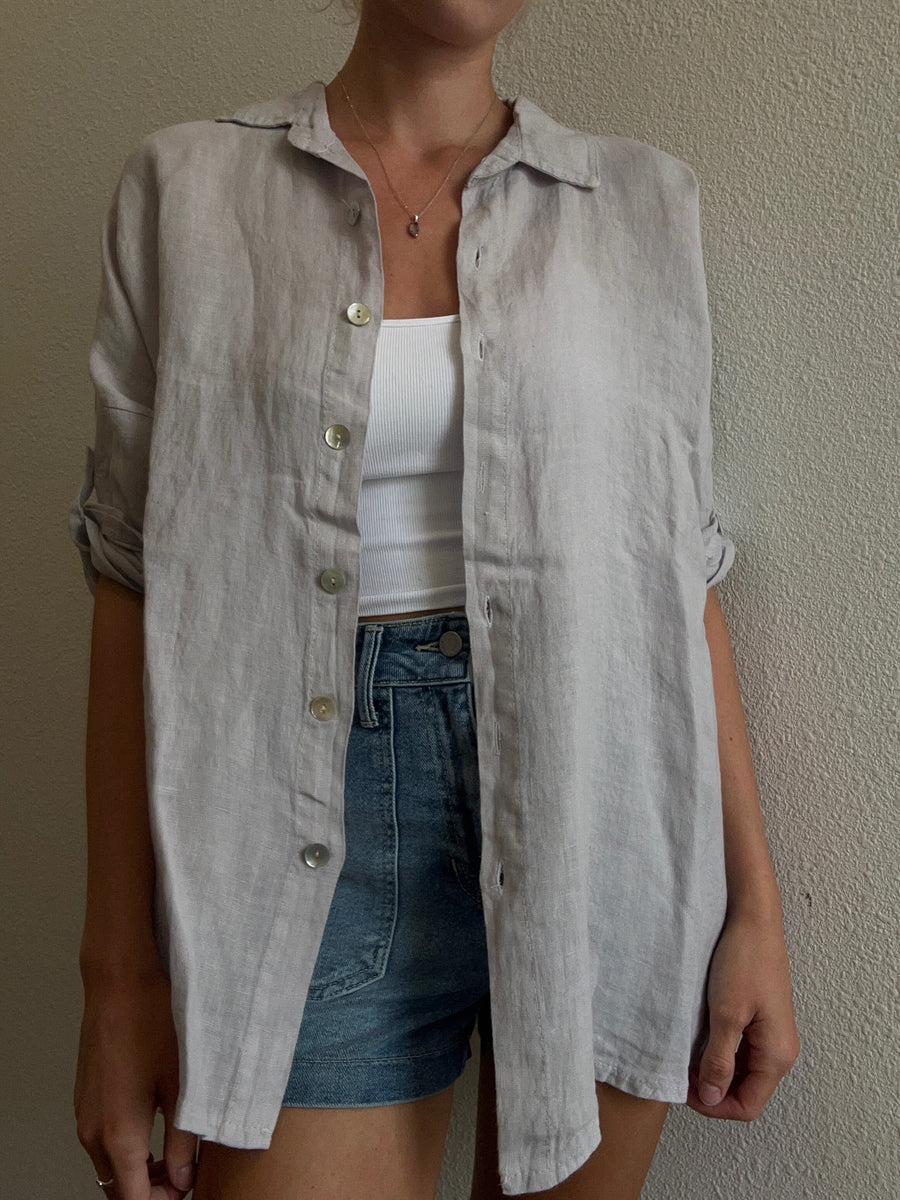 Featuring a quarter sleeve linen button up in the color silver 