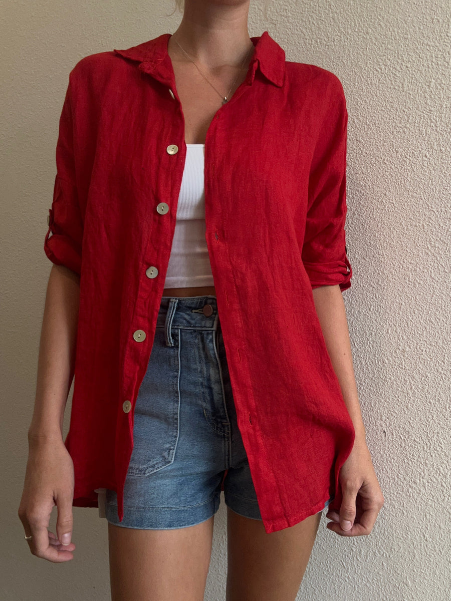 Featuring a quarter sleeve linen button up in the color red 