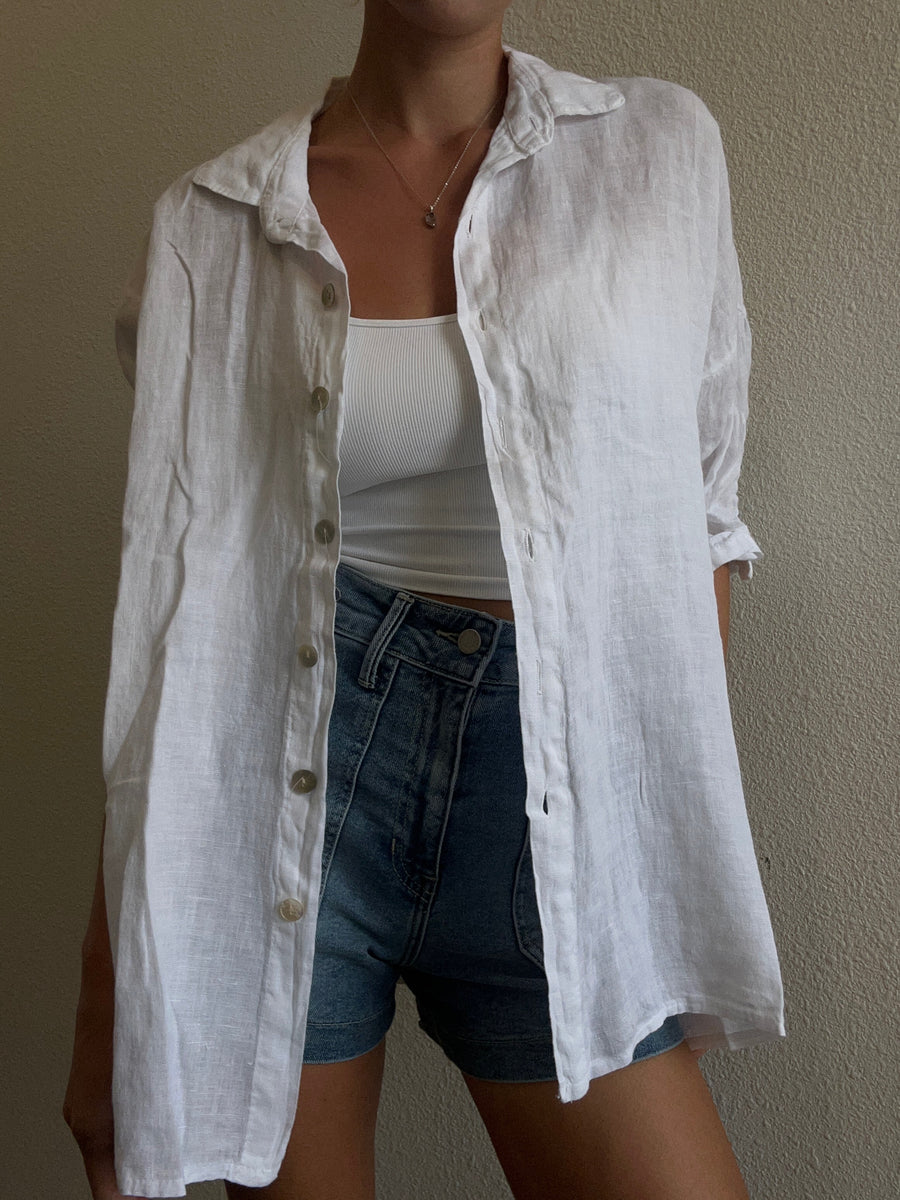 Featuring a quarter sleeve linen button up in the color white 