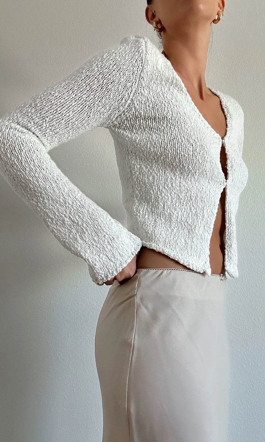 Long sleeve, open-front top with hook and eye closure. 