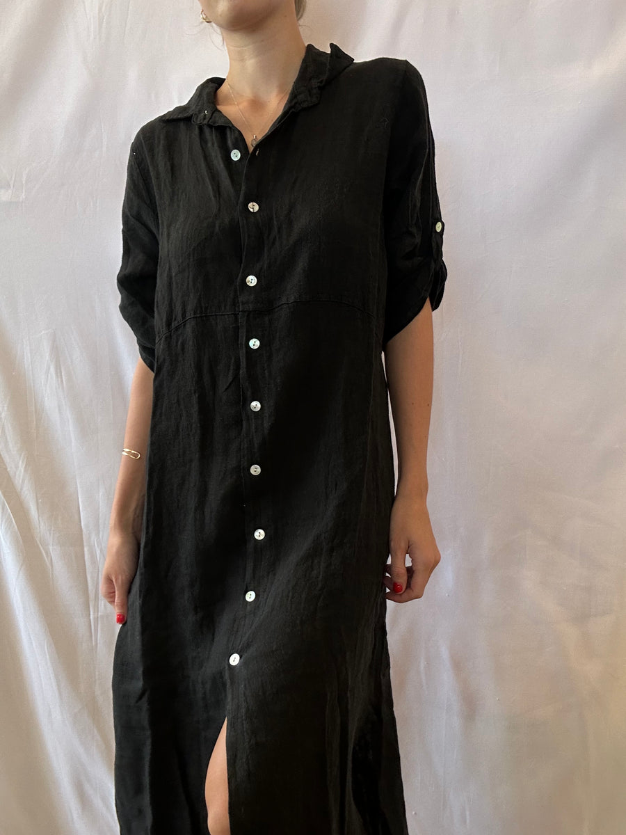 Featuring a button up linen midi dress in the color black 