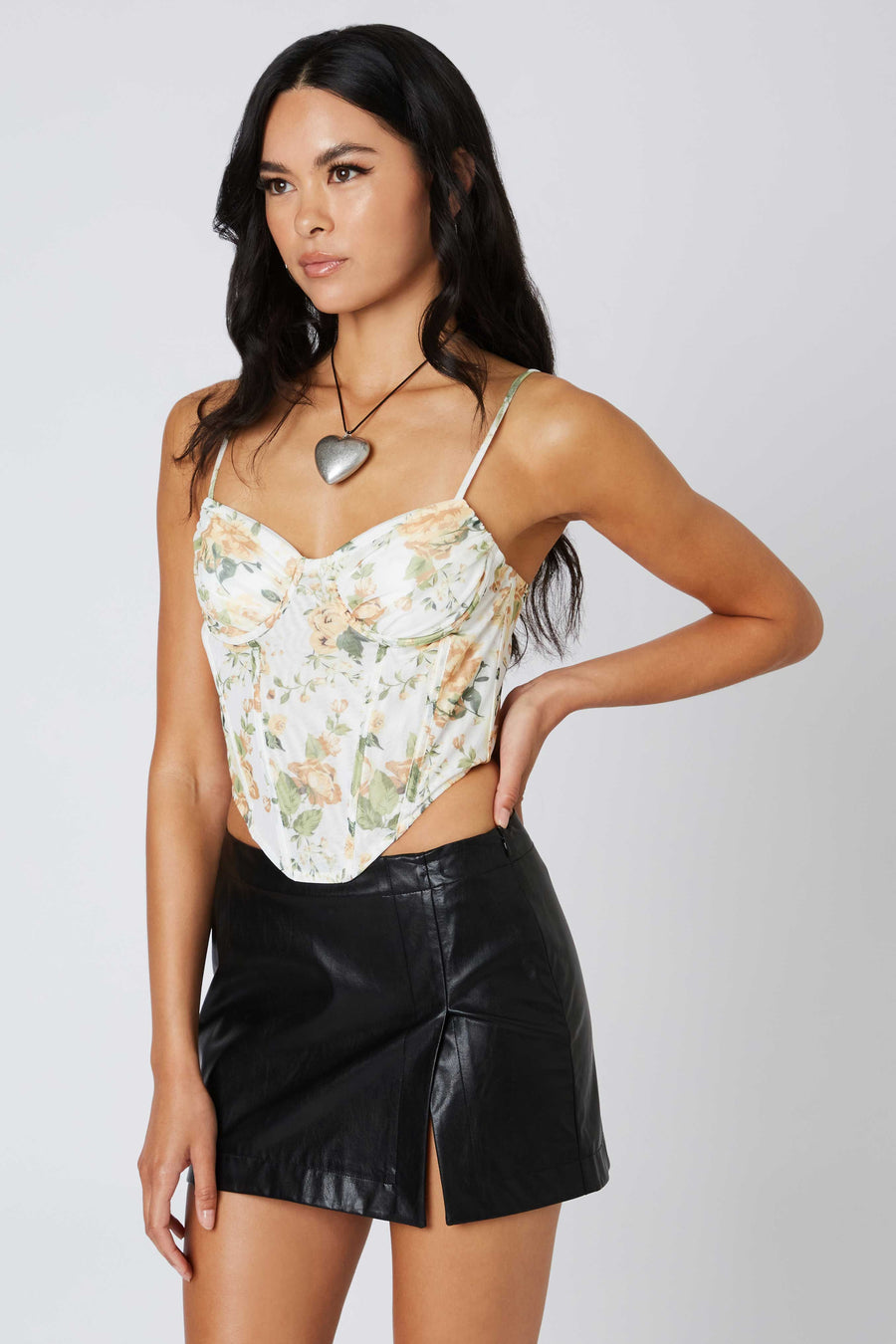 Corset style top with mesh fabric and floral pattern.