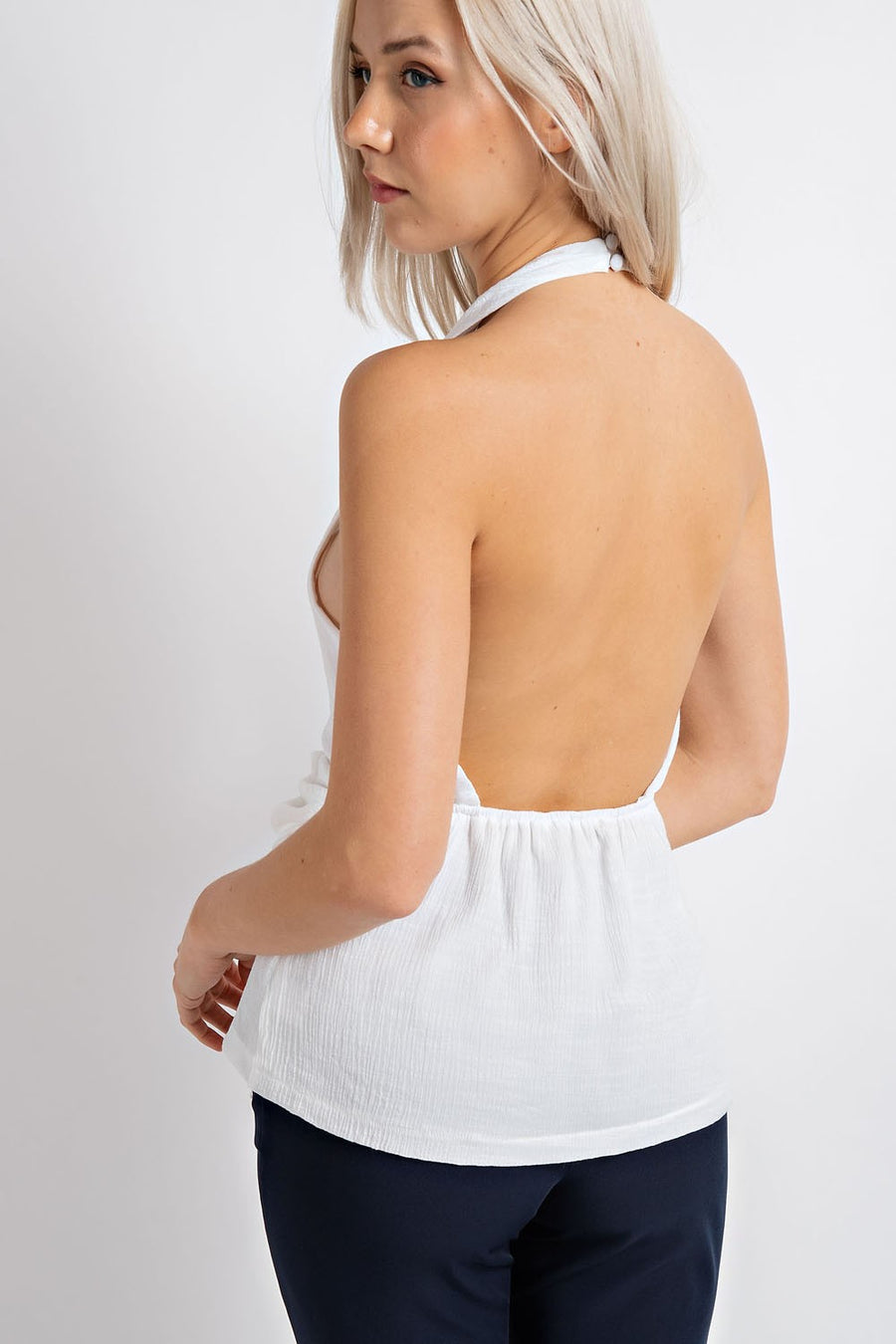 Sleeveless halter top with front knot detail.