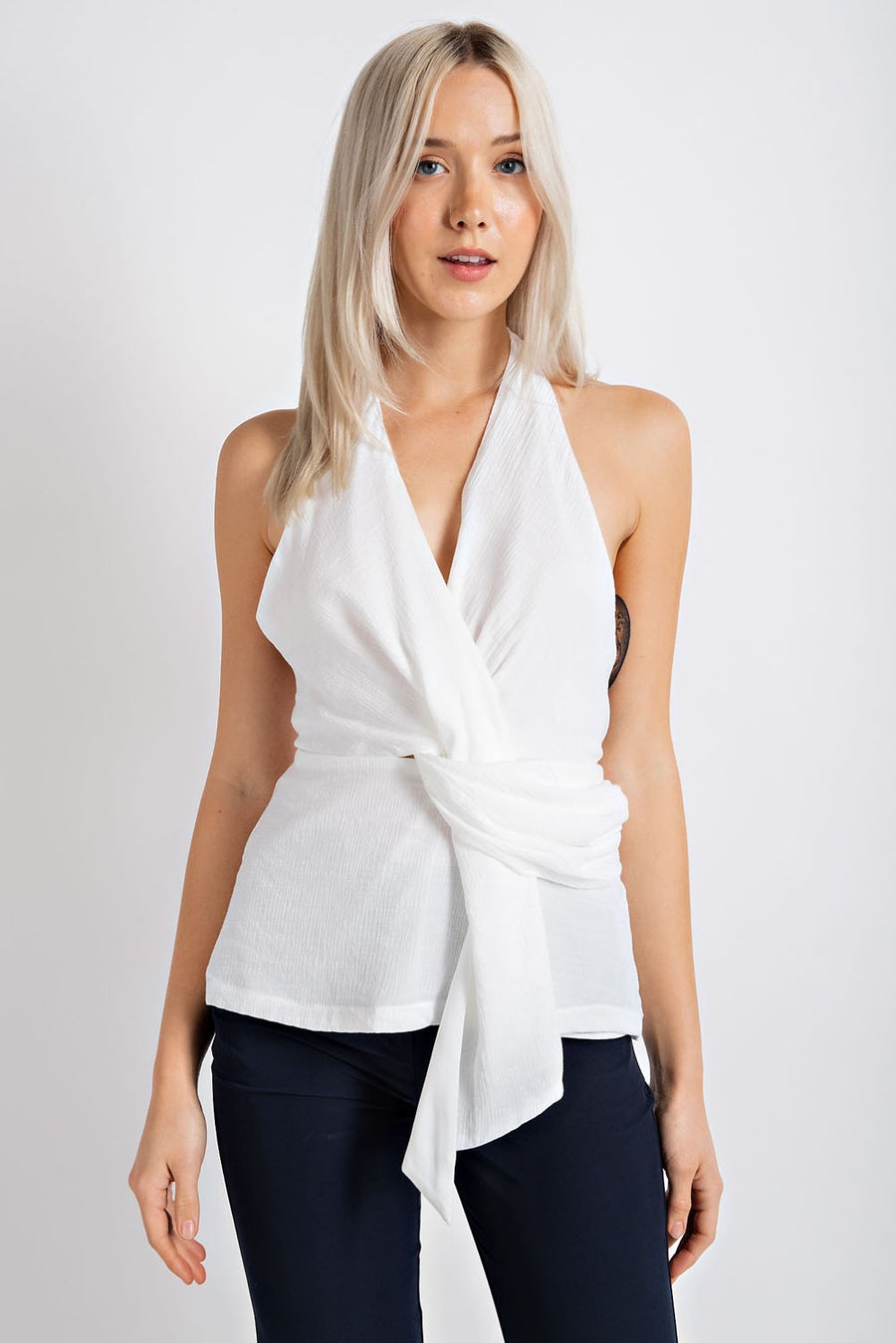 Sleeveless halter top with front knot detail.
