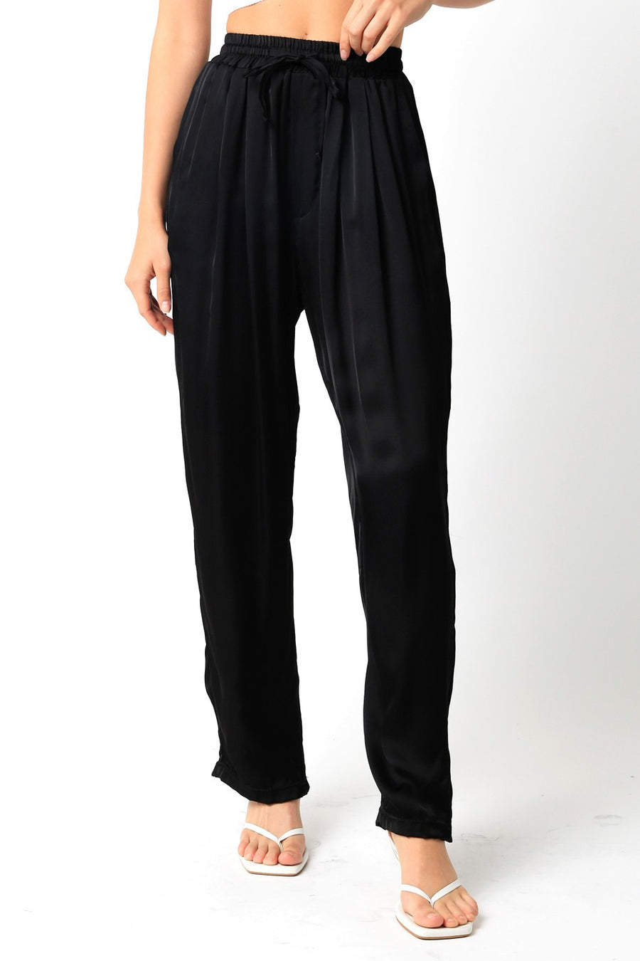 Loose fit pants with pleated waistband and drawstring waist.