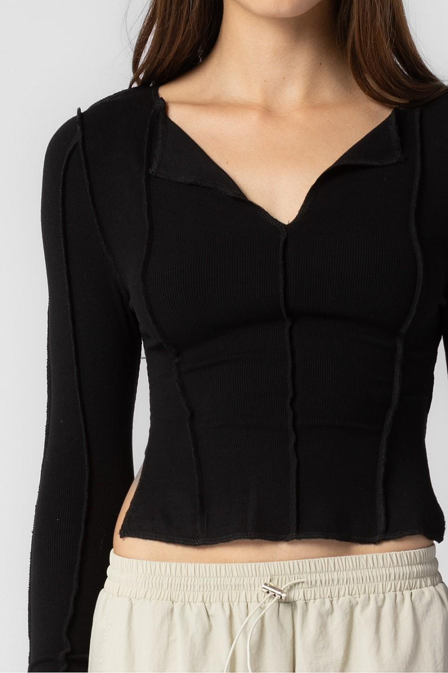 Black long sleeve cropped top with side slits.