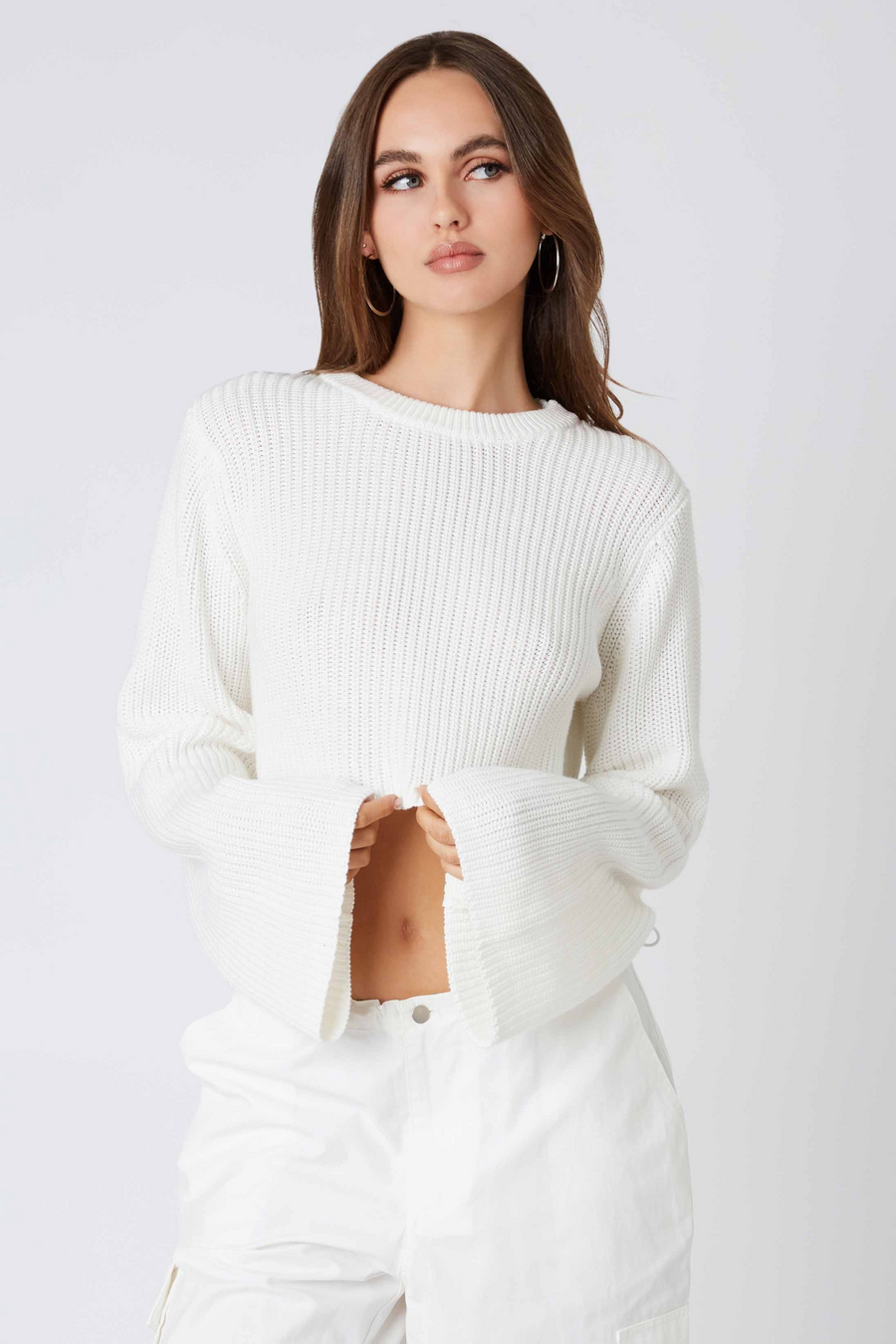 White cropped sweater with bell sleeves. 