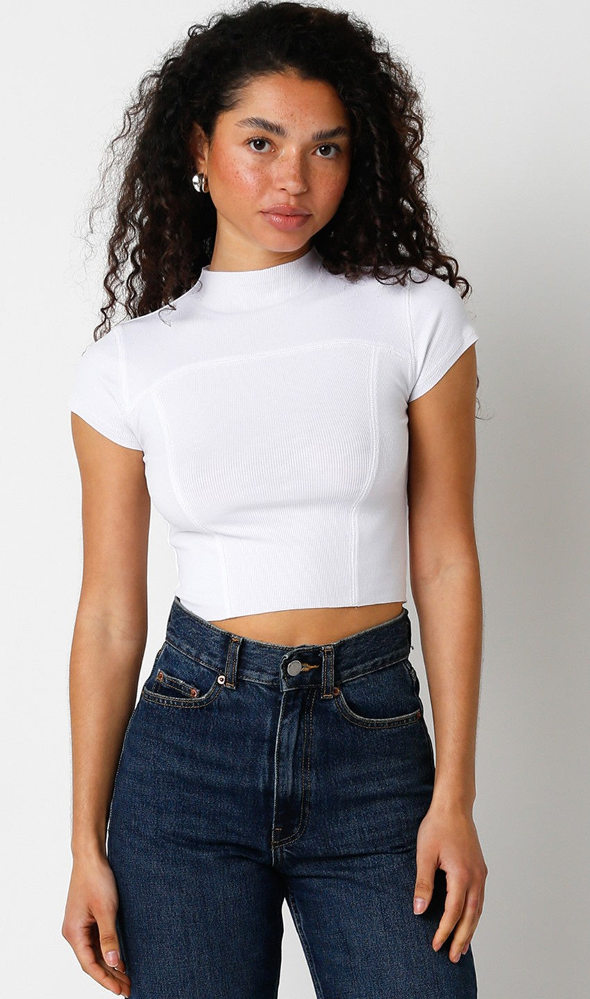 Featuring a short sleeve with a mock neck and a cropped fit.