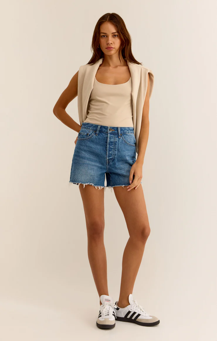 High-rise shorts with raw hemline, no rips.