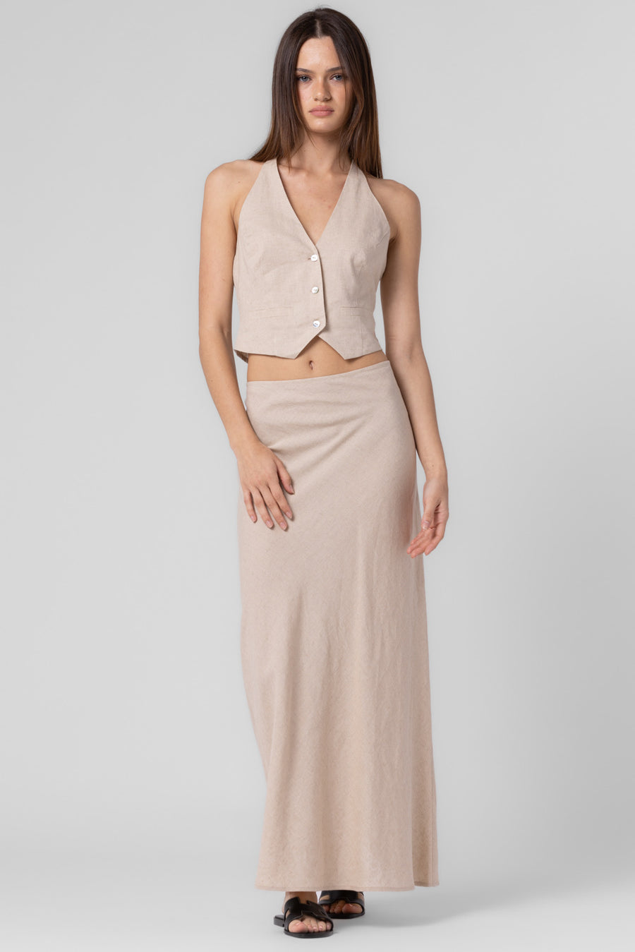 Pairs with the matching Leland Halter Vest  Featuring a solid color midi skirt In the color oat 