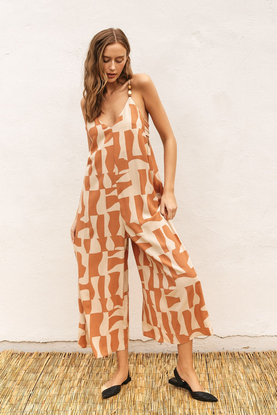 Patterned jumpsuit with a tie back.