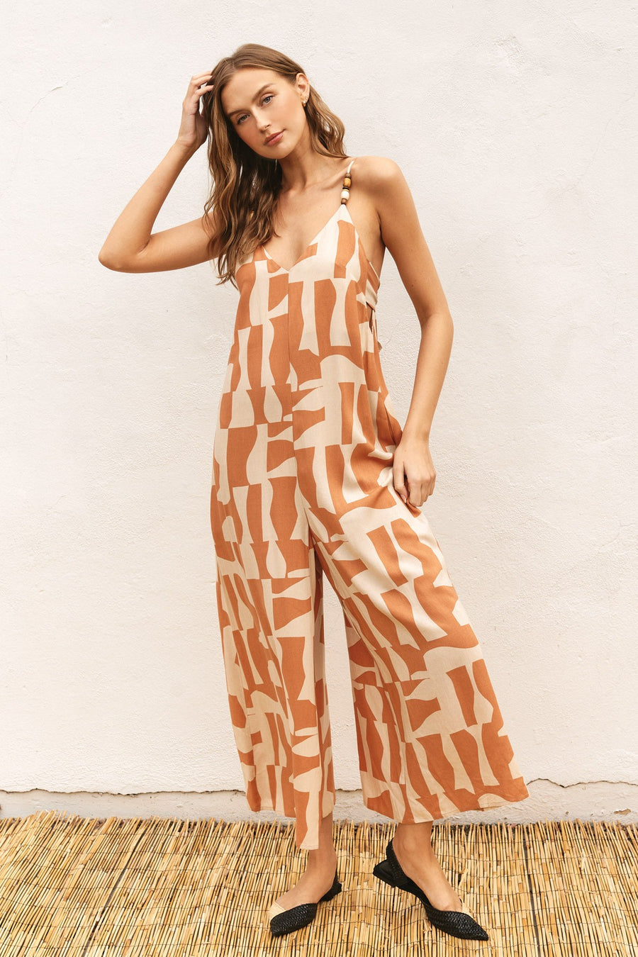 Patterned jumpsuit with a tie back.