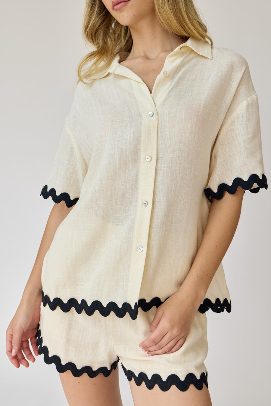 Short sleeve button down with wave trim detail.