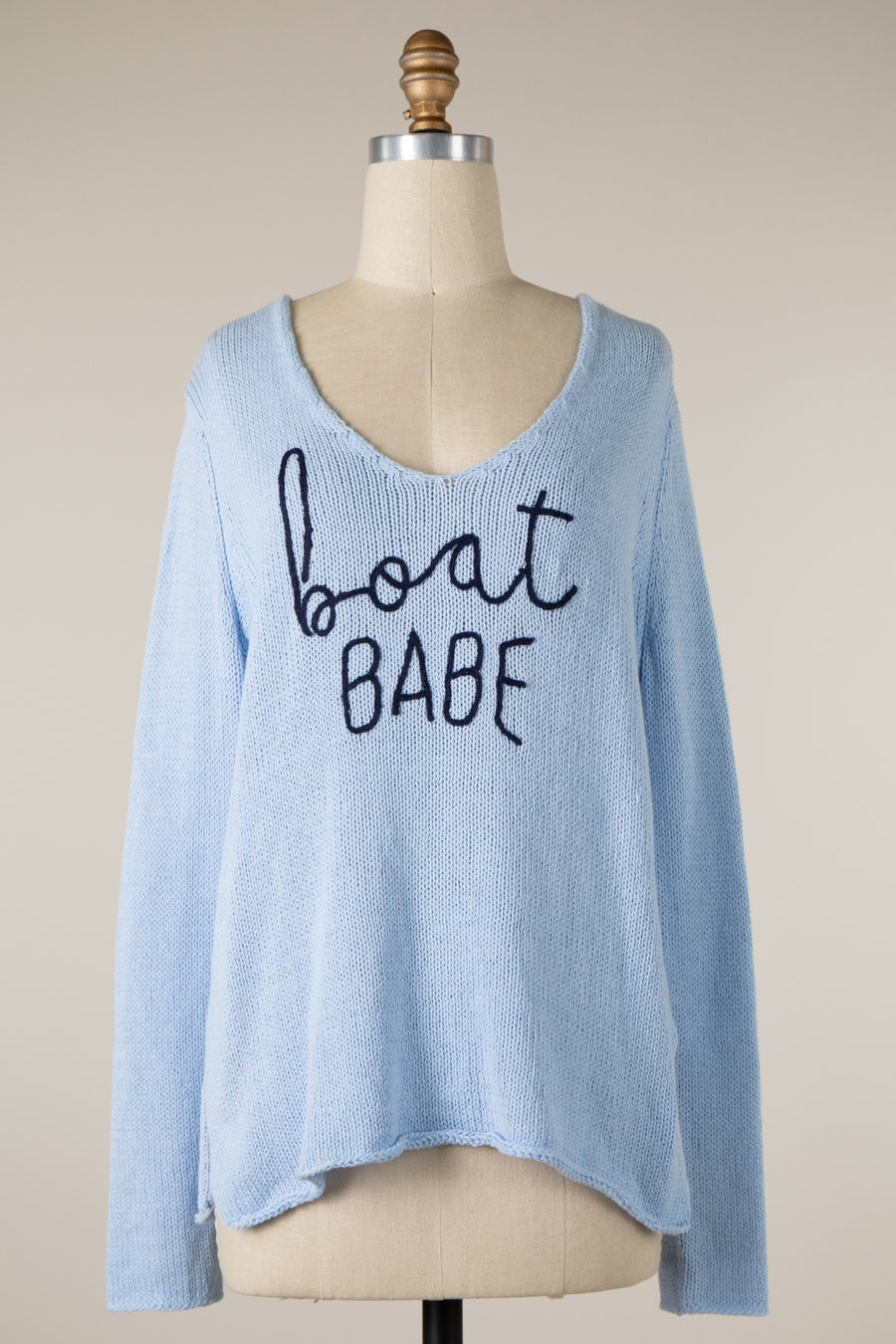 Relaxed fit, knit sweater with cursive writing across the front.