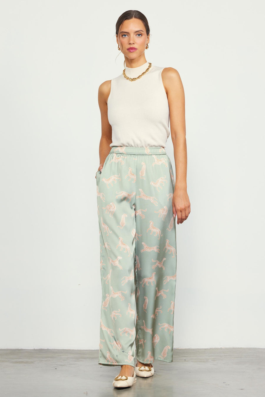 Featuring a satin sage colored animal print pant