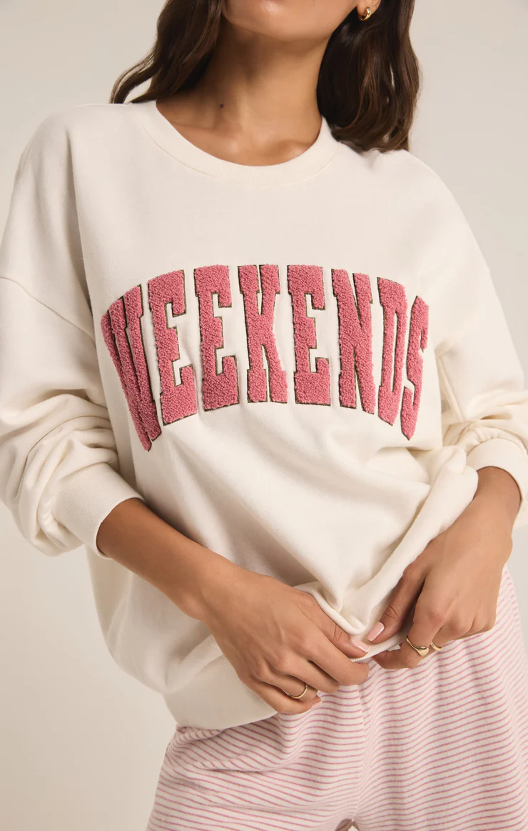 Featuring a bone colored oversized crew neck with pink lettering