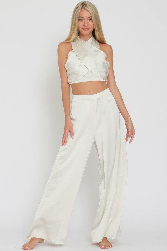 Pairs with the matching Kaylor Hlater Top

Featuring a silky loose fit pant with a side zip closure in the color ivory 