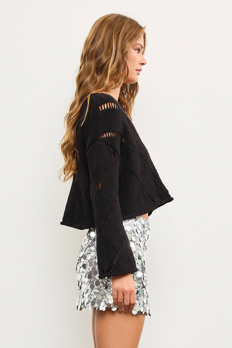 Cropped, knitted sweater featuring open knit details.