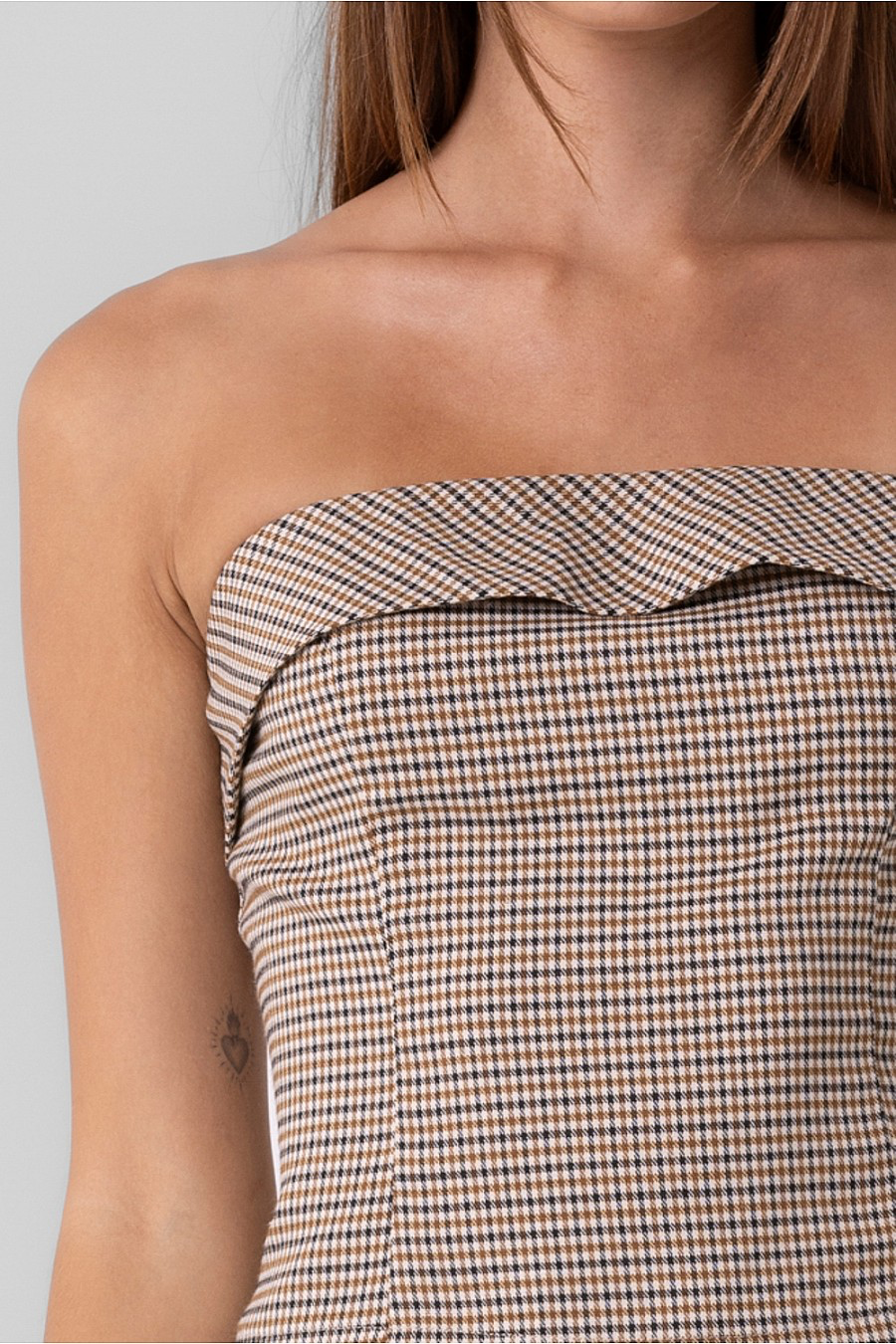 Strapless plaid top with zipper closure.