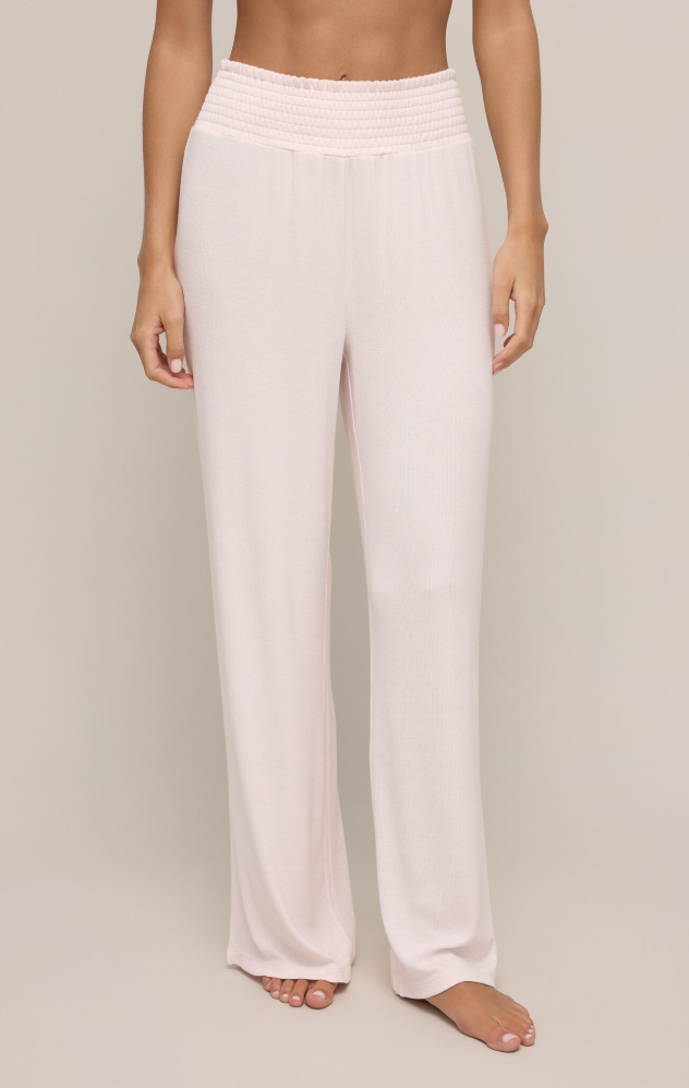 Featuring a high rise loose fit pant with a smocked waist and ribbing in the color whisper pink 